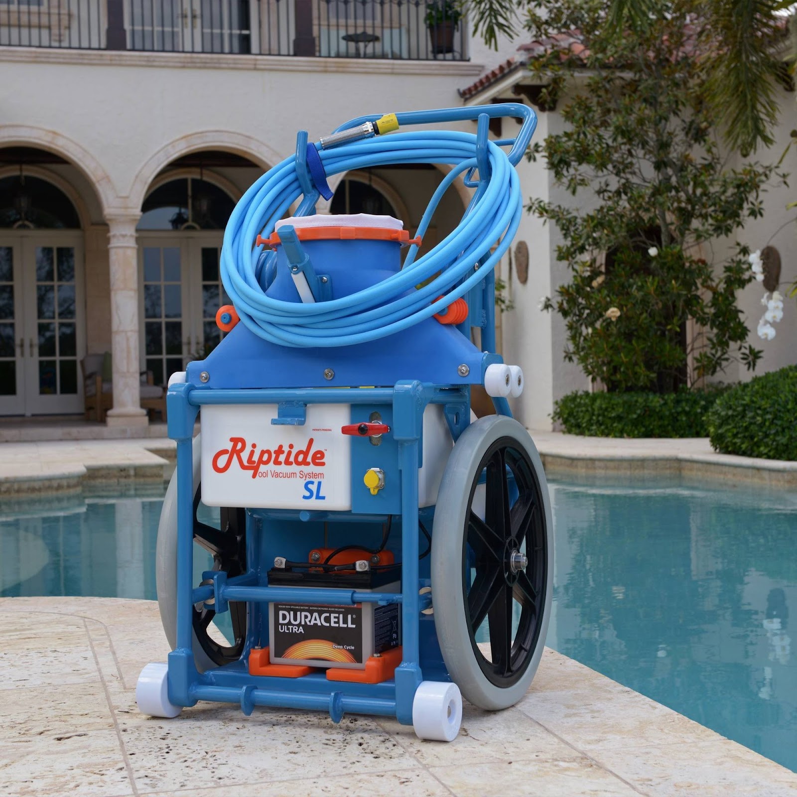 Riptide SL portable pool vacuum system on poolside patio